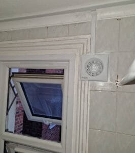 Extractor fan installation with a new core drilling hole by faraday engineering electricians