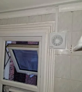 Extractor fan installation with a new core drilling hole by faraday engineering electricians